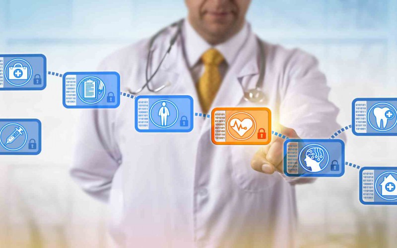 healthcare_2000 Unrecognizable clinician accessing block in blockchain of medical records. Internet metaphor for data management, peer to peer networking, distributed ledger with mechanism to prevent modification.